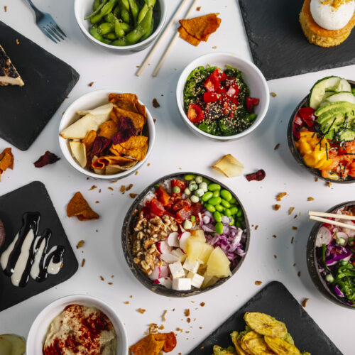 Variety of healthy and delicious poke basins on the restaurant table