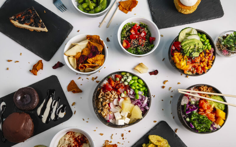 Variety of healthy and delicious poke basins on the restaurant table